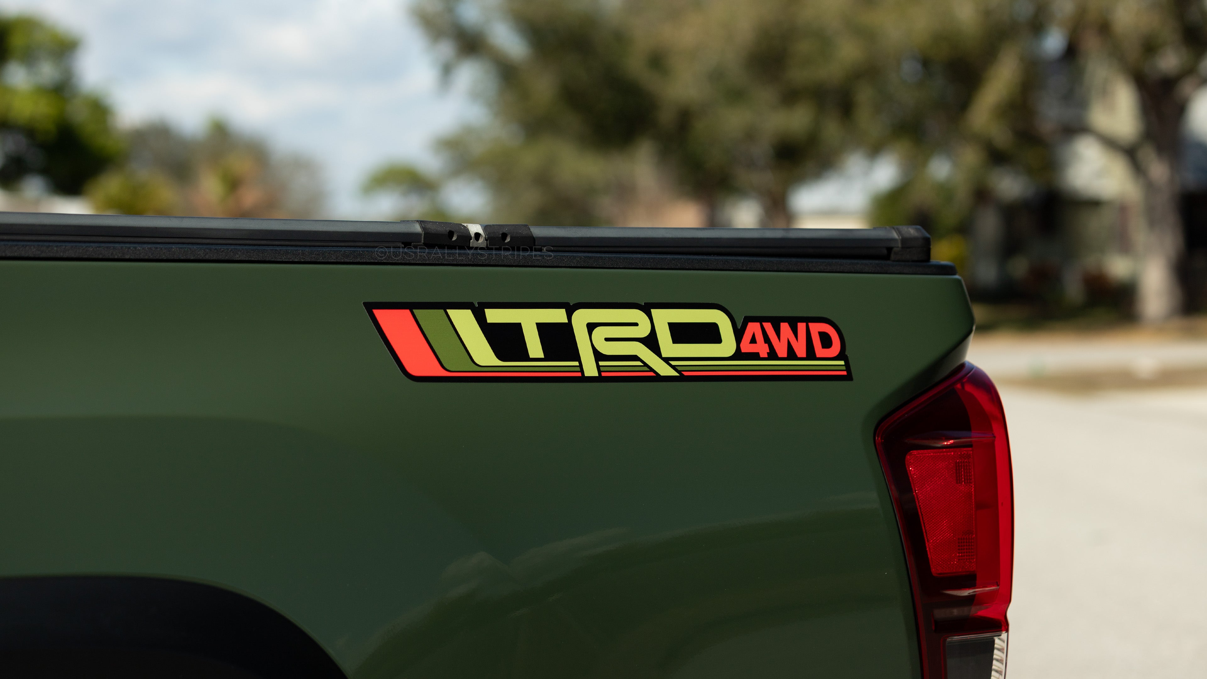 Army green Tacoma with 'TRD 4WD' decal on the bedside